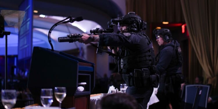 Agents stand guard with their rifles after a shooting reportedly took place at the White House Correspondents Dinner in Washington, DC on April 25, 2026.