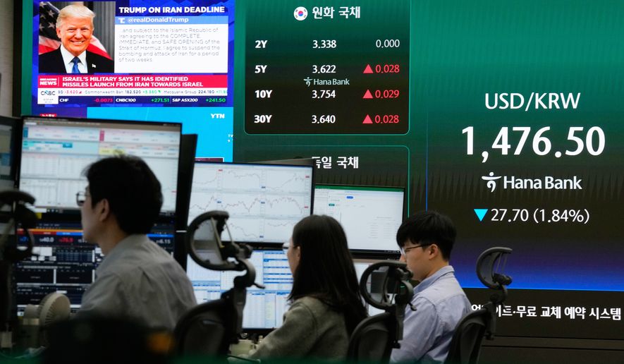 U.S. President Donald Trump is seen on a screen as traders work at the foreign exchange dealing room of the Hana Bank headquarters in Seoul, South Korea, Wednesday, April 8, 2026. (AP Photo/Ahn Young-joon)