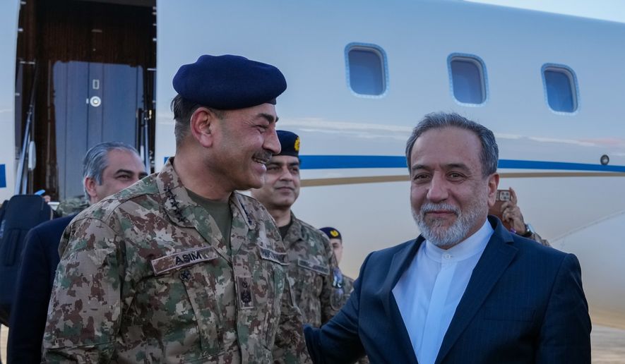In this photo released by the Iranian Foreign Ministry, Pakistan's Army Chief Field Marshal Gen. Asim Munir, left, is welcomed by Iranian Foreign Minister Abbas Araghchi upon his arrival in Tehran, Wednesday, April 15, 2026. (Iranian Foreign Ministry via AP)