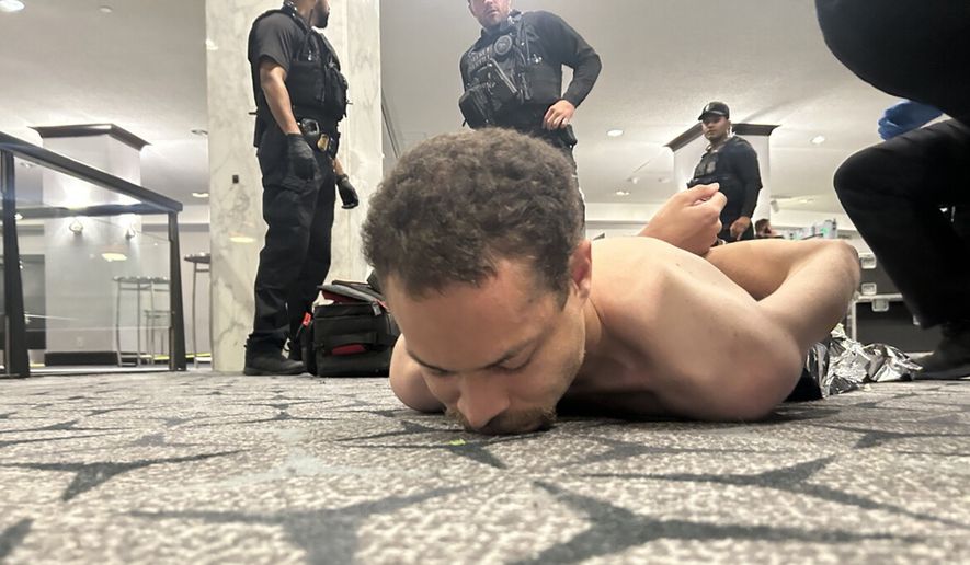 A suspect is apprehended on the ground by law enforcement during the White House Correspondents Dinner, Saturday, April 25, 2026, in Washington. (Screenshot from Truth Social post)