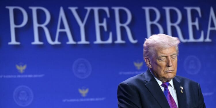 President Donald Trump bows his head in prayer during the National Prayer Breakfast at the Washington Hilton in Washington, D.C., on Feb. 5, 2026.