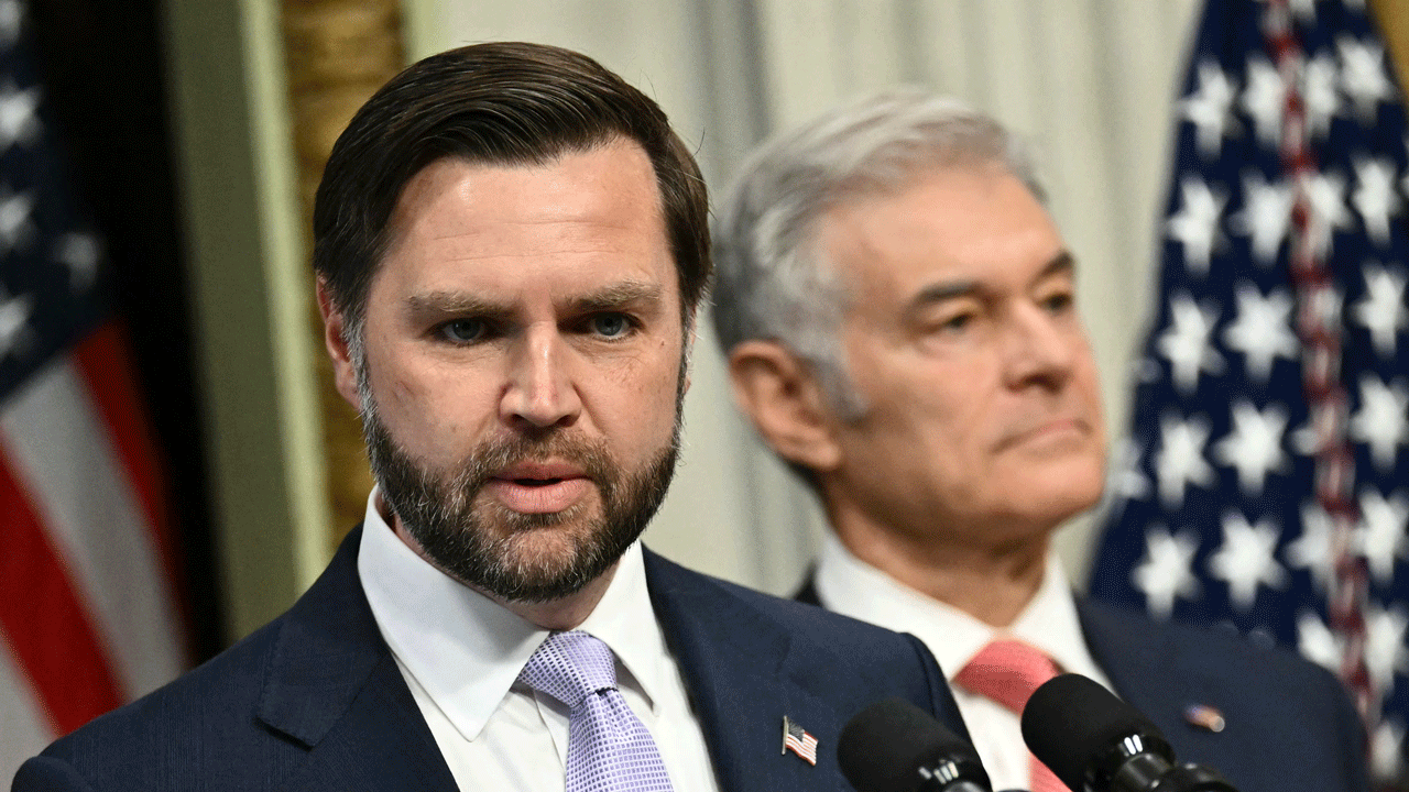 Vice President Vance and Dr. Mehmet Oz stand at a podium.