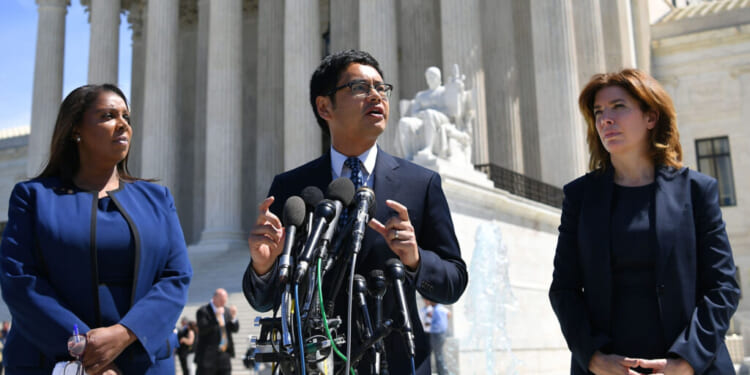 Then-ACLU's Voting Rights Project Director Dale Ho (C) flanked by New York Attorney General Letitia James (L) and Director of the Census for New York City Julie Menin (R) speaks to reporters outside of the US Supreme Court in Washington, DC on April 23, 2019. - In March 2018, US Secretary of Commerce Wilbur Ross announced he was going to reintroduce for the 2020 census a question on citizenship abandoned more than 60 years ago. The decision sparked an uproar among Democrats and defenders of migrants -- who have come under repeated attack from an administration that has made clamping down on illegal migration a hallmark as President Donald Trump seeks re-election in 2020. (Photo by MANDEL NGAN / AFP) (Photo credit should read MANDEL NGAN/AFP via Getty Images)