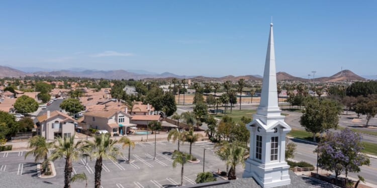 An aerial view of a sprawling single family home neighborhood and church in Menifee, California.