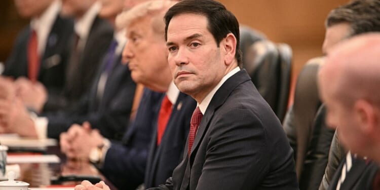 Secretary of State Marco Rubio looks on Thursday as President Donald Trump meets with China's President Xi Jinping at the Great Hall of the People in Beijing.