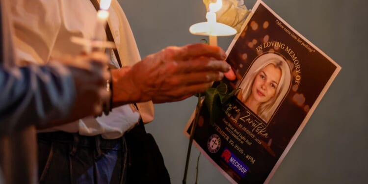 Members of the local community hold a vigil in honor of the late Iryna Zarutska on Sept. 22, 2025, who was stabbed to death on a commuter train by a repeat offender.
