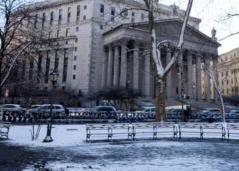 The New York Supreme Court is surrounded by cars on a snowy day on January 19, 2026.