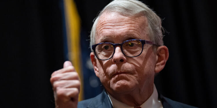 Ohio Gov. Mike DeWine stands with his thumbs up.