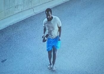 The suspect in a Minnesota fraud investigation is seen on surveillance video fleeing down a ramp.