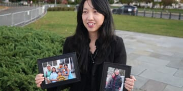 Grace Jin Drexel, the daughter of detained Chinese pastor Jin Mingri, holds up framed photos of Mingri and his family in Washington, DC on Oct. 30, 2025.