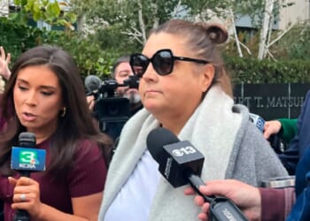 Dana Williamson, a former chief of staff to Gov. Gavin Newsom, center, leaves the federal courthouse in Sacramento, California, surrounded by reporters in a Nov. 12 file photo.