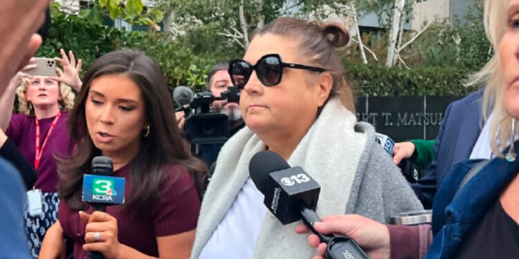 Dana Williamson, a former chief of staff to Gov. Gavin Newsom, center, leaves the federal courthouse in Sacramento, California, surrounded by reporters in a Nov. 12 file photo.