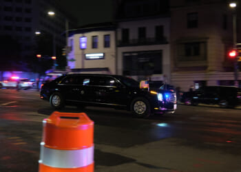 A vehicle of a motorcade flees into the night after the White House Press Correspondents’ Dinner incident.