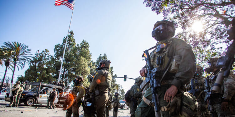 U.S. Border Patrol and protesters clash after a raid was conducted by Immigration and Customs Enforcement June 7, 2025.