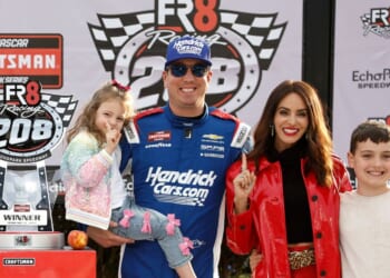 Kyle Busch celebrates with daughter, Lennix Busch, son, Brexton Busch, and wife, Samantha Busch in victory lane after winning the NASCAR Craftsman Truck Series Fr8 Racing 208 at Echo Park Speedway on Feb. 21, 2026, in Hampton, Georgia.