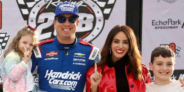 NASCAR champion Kyle Busch poses with his family after winning the NASCAR Craftsman Truck Series Fr8 Racing 208 at Echo park Speedway on Feb. 21, 2026 in Hampton, Georgia.