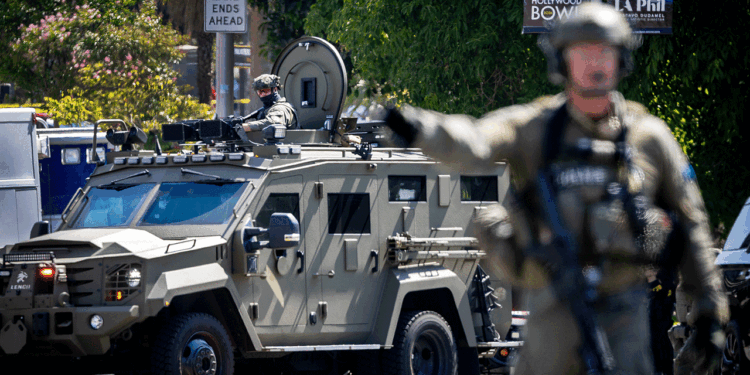 Federal authorities stand in MacArthur Park in Los Angeles.