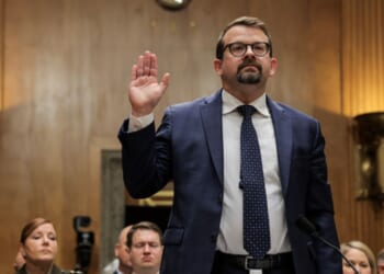 James Erdman III lifts his right hand as he takes the oath to testify to the Senate Homeland Protection and Government Affairs Committee on May 13, 2026.