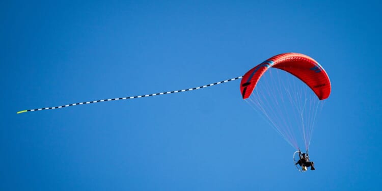 A paraglider flies through the sky on March 21, 2026, in Torrington, Wyoming.