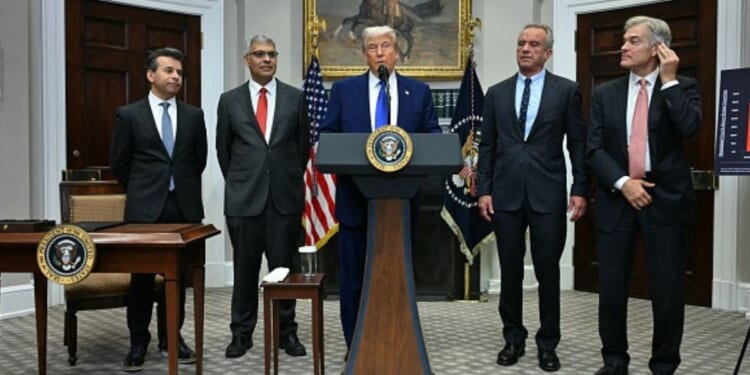 President Trump stands with administration officials such as Secretary of HHS Kennedy, FDA Commissioner Makary, and others on May 12, 2026.