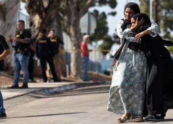 Two women react as they leave a reunification center following the shooting at the Islamic Center of San Diego in southern California Monday.