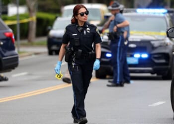 An officer walks on the scene of the Cambridge, Massachusetts incident.