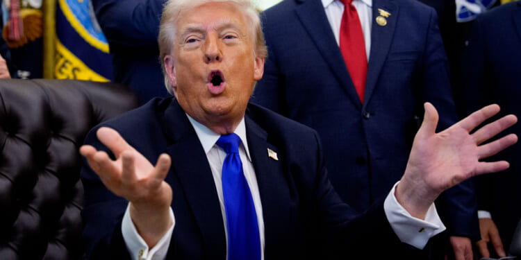 President Donald Trump speaks to reporters in the Oval Office.
