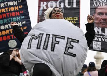 A woman dressed as a mifepristone pill dances with supporters of Planned Parenthood and pro-choice activists during a rally outside the US Supreme Court on April 2, 2025, in Washington, DC. (DREW ANGERER/AFP/Getty Images)