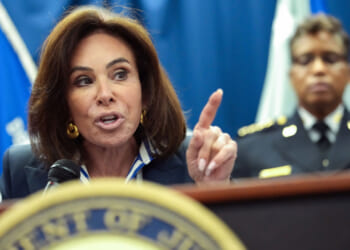 Close-up of Jeanine Pirro speaking at podium and pointing with her left hand.
