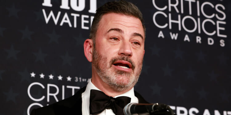 Close-up of Jimmy Kimmel speaking into a microphone at the Critics Choice Awards.