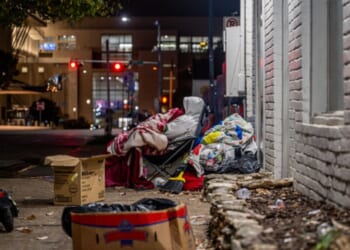 A southern street is strewn with trash.