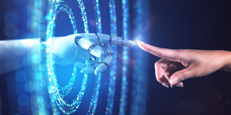 Graphic showing a robotic AI-driven hand reaching through rings of blue light to touch forefingers with a human hand.