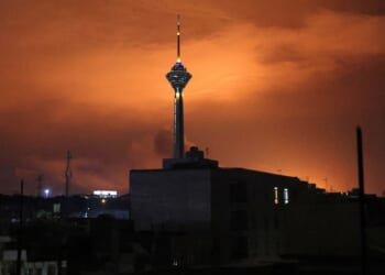 Milad (Birth) Tower, the tallest tower in Iran at 435 metres, is pictured before a lit up sky following airstrikes in Tehran on March 7.