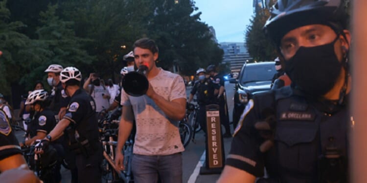 Jacob Wohl, now a convicted felon, is pictured taunting leftist protesters during a "Trump/Pence Out Now" rally in August 2020.