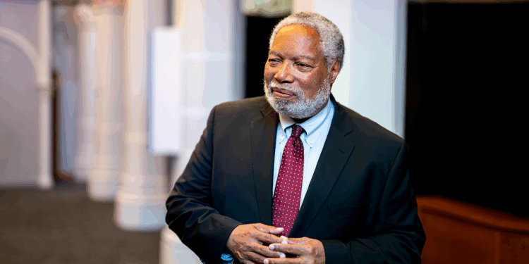 Lonnie Bunch III stands in the "American Aspirations" exhibit at the Smithsonian Castle on the National Mall.