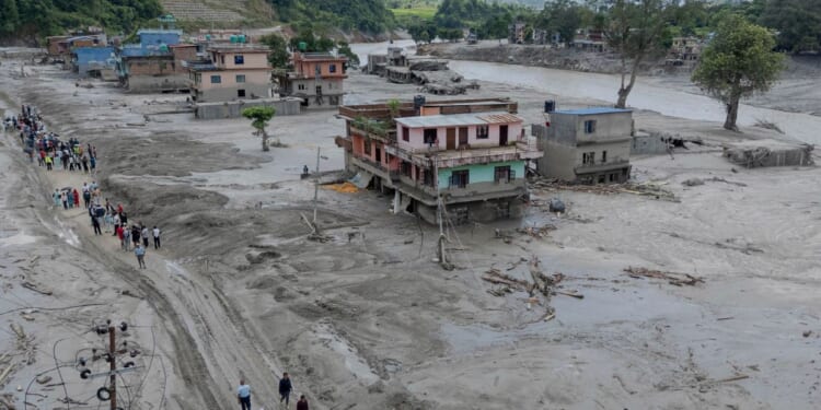 Death toll from floods rises with rescuers in Nepal and China working to find hundreds missing