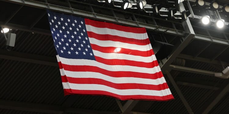 The American flag flies below black roof scaffolding on July 25, 2026 in Houston, Texas.