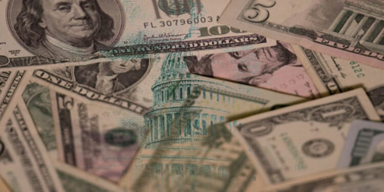Dollar bills are pictured with an overlay of the United States Capitol Building.