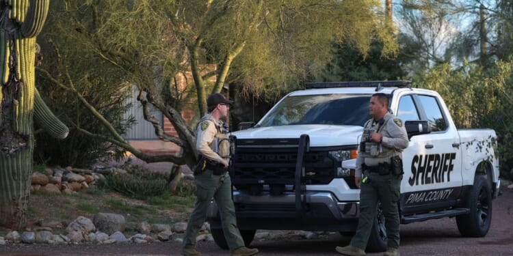 Pima County Sheriff's deputies are seen in front of Nancy Guthrie's residence during a shift change on Feb. 19, 2026, in Tucson, Arizona.