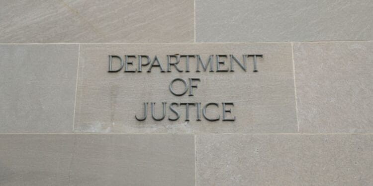 The Department of Justice logo is showcased on the side of a building.