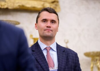 Turning Point USA co-founder Charlie Kirk stands in the back of the room as President Donald Trump speaks during a swearing in ceremony for interim U.S. Attorney for Washington, D.C. Jeanine Pirro in the Oval Office of the White House on May 28, 2025, in Washington, D.C.