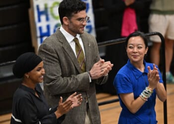 Hasan Piker stands beside Wisconsin Gubernatorial candidate Francesca Hong and Congresswoman Ilhan Omar at a rally in Milwaukee, Wisconsin.