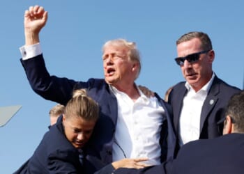 Then-Republican presidential candidate Donald Trump raises a defiant fist after the July 2024 assassination attempt on him in Butler, Pennsylvania.