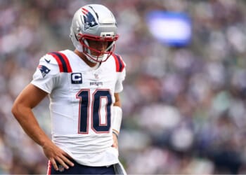 Drake Maye #10 of the New England Patriots stands on the field Wednesday during the NFL football game against the Seattle Seahawks at Lumen Field in Seattle, Washington.