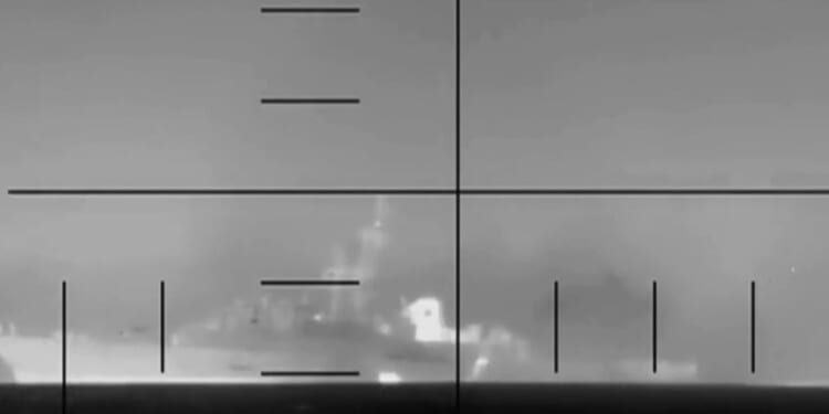 A camera shot of an Iranian frigate, the IRIS Dena, sinking while in flames on March 4, 2026.