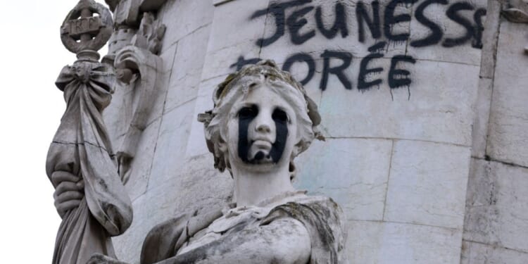 This photograph shows the "Egalite" statue with black tears and a graffiti reading "Golden Youth" in the "Monument a la Republique" at the Place de la Republique in Paris on Oct. 21, 2026.