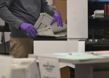 An election worker counts ballots inside the Maricopa County Tabulation and Election Center in Phoenix, Arizona, in a file photo dated Nov. 6, 2024.