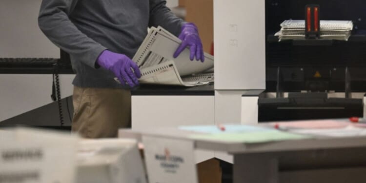 An election worker counts ballots inside the Maricopa County Tabulation and Election Center in Phoenix, Arizona, in a file photo dated Nov. 6, 2024.