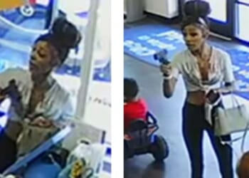 A woman waves a gun in an Indianapolis second-hand clothing store in July.