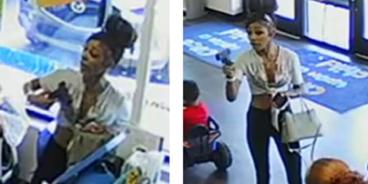 A woman waves a gun in an Indianapolis second-hand clothing store in July.